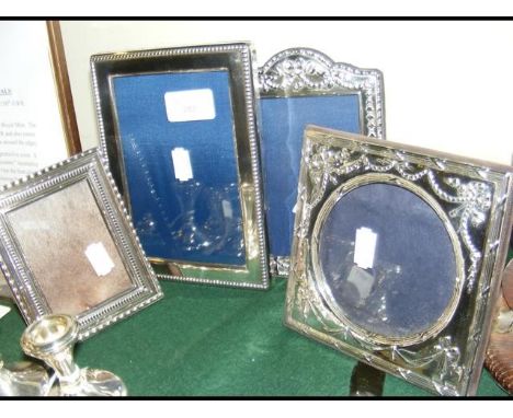 Four silver photo frames 