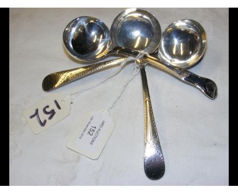 A pair of silver sauce ladles with London hallmarks, together with one other 