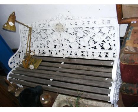 A two seater garden bench with cast iron back depicting lilies - length 130cm 
