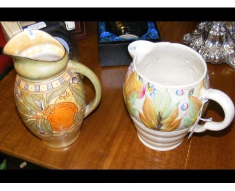 A Clarice Cliff jug with floral design, together with a tube lined Charlotte Rhead jug - 25cm high 