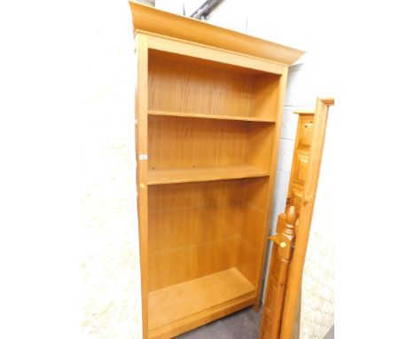 An M &amp; S Home light oak freestanding bookcase, with fixed dentil cornice and four shelves, on shaped stiles, 195cm high, 