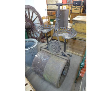 A vintage cast iron garden lawn roller 