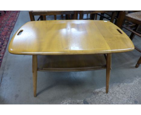An Ercol Blonde elm and beech two tier tray top table 
