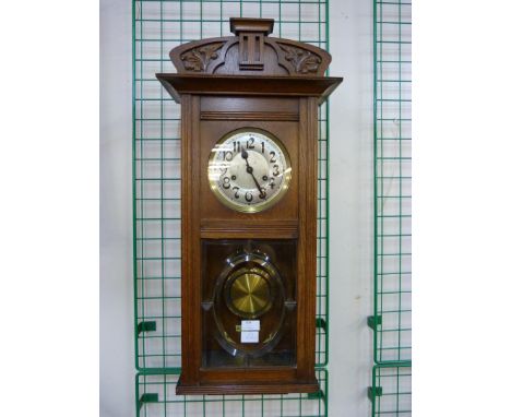 An early 20th Century oak wall clock 