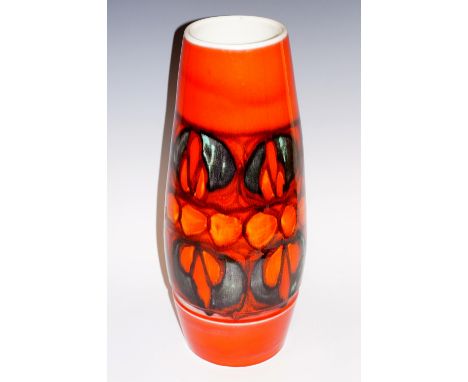 A large Poole pottery Delphis rocket vase, decorated with a band of green, black and orange red motifs above a ribbed border,