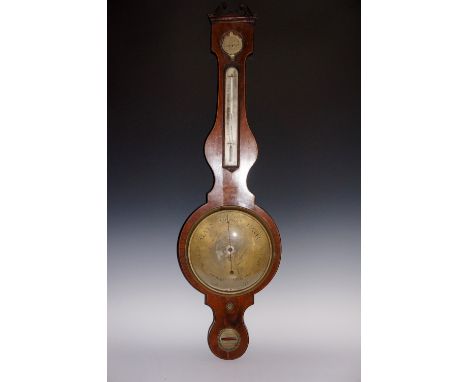 A George III mahogany wheel barometer with thermometer the swan neck pediment above a dry/damp dial and silvered thermometer,