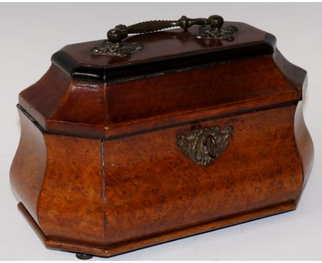 An early George III amboyna veneered bombé shaped tea caddy, ebony strung with beaded and foliate clasped handle, ebonised ov