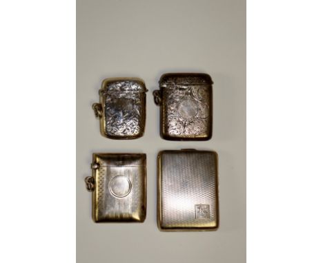 A Victorian foliate engraved vesta case, 5 cm high; another, 4.25 cm high; an Edwardian engine turned vesta with vacant circu