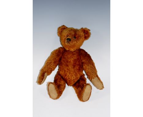 A Margarete Steiff Gmbh teddy bear, dark plush mohair with black button eyes and with Steiff button to the ear, tilt growler,