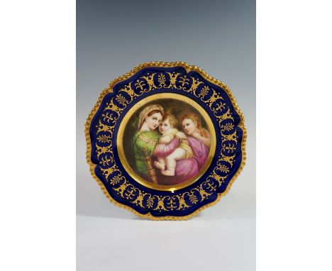 A shaped circular Worcester cabinet plate finely painted to the centre with seated Madonna and infants, the broad Royal blue 