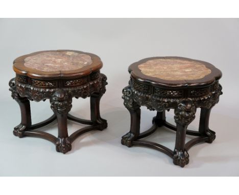 A good pair of Chinese hardwood jardiniere stands the shaped circular tops inset with rosso marble panels above a foliate car