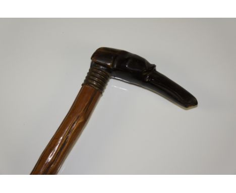 A walking stick with horn greyhound head handle with reeded brass collar, rustic wood shaft, 88 cm long