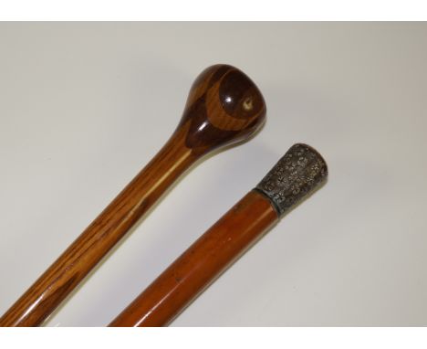 A bamboo walking stick with metal pommel, reeded and embossed, 81 cm long; a laminate walking stick with ball pommel and bras