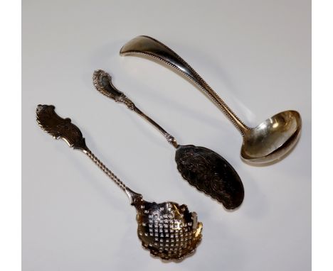 A Dutch beaded Old English pattern ladle, marked; a Dutch butter knife with foliate engraved blade and cast stem, marked for 