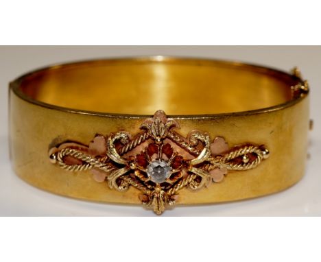 A Victorian 14 ct gold bangle set rose cut diamond in pierced flower head, rope twist and leaf frame, 6 cm wide, stamped .585