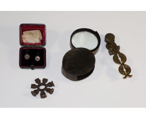 A horn cased magnifying glass, 6.5 cm wide; a set of Harrison Warranted sovereign scales, 10 cm wide; a multi seal, a pair of