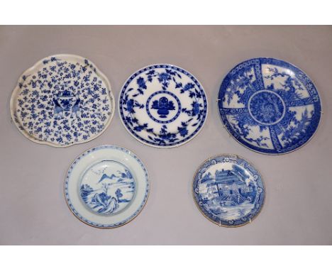 A Chinese blue and white shaped circular dish painted to the centre with two figures carrying a lidded urn on a ground of flo