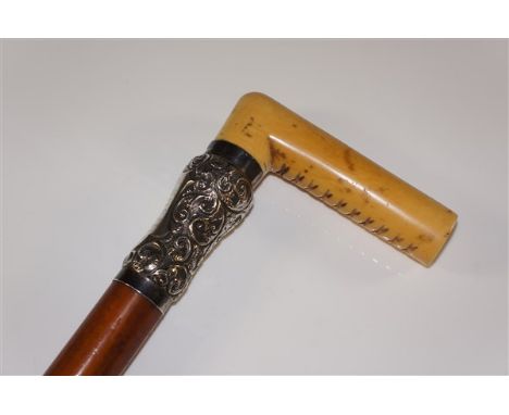 A bamboo walking stick with ivory handle the deep silver foliate embossed collar with a shield shaped cartouche inscribed 'Pr