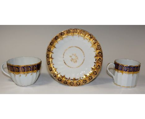 A Worcester lobed trio, with band of gilt filled ovals on a Royal blue ground, saucer 14.5 cm diameter, Circa 1800