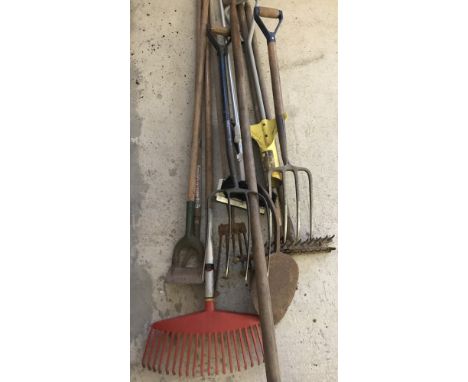 A collection of vintage garden tools to include rakes, hoes, forks and a rabbiting spade.  