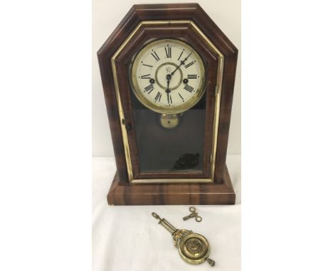 A One day Spring strike "Celtic" Waterbury Clock Co wooden cased mantle clock. With original pendulum and key. In need of att
