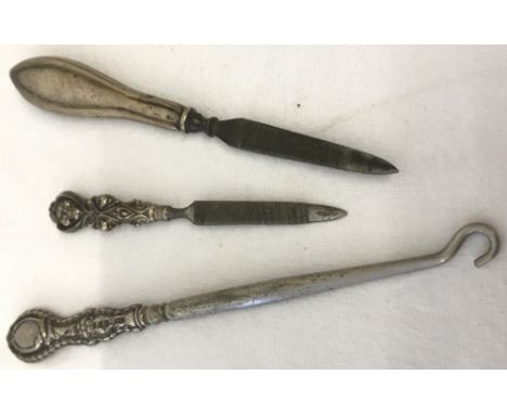 3 silver handled ladies vanity items, a button hook together with 2 nail files. All hallmarked silver, one with a Chester Ass