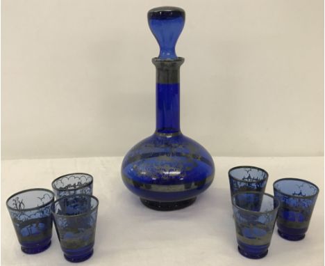 A vintage Blue glass liquer set With silver coloured overlay decoration of building and gondolas. 