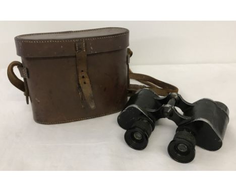 A leather cased pair of vintage binoculars.  