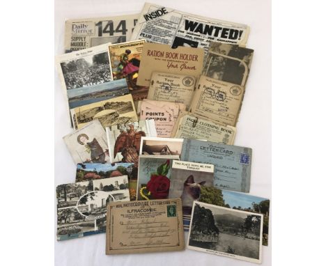 A collection of vintage postcards and mixed ephemera. To include Commemorative replica war time newspapers and WWII Ration bo