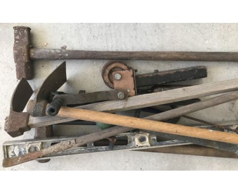 A collection of vintage wooden and metal tools. To include sledge hammers, adze, crow bars, wrench and Record 24 Stilson grea