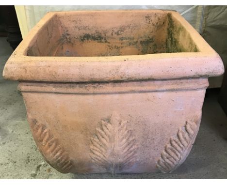 A large square shaped terracotta garden planter with fern decoration to corners and sides.  Approx. 35cm² x 31cm tall.