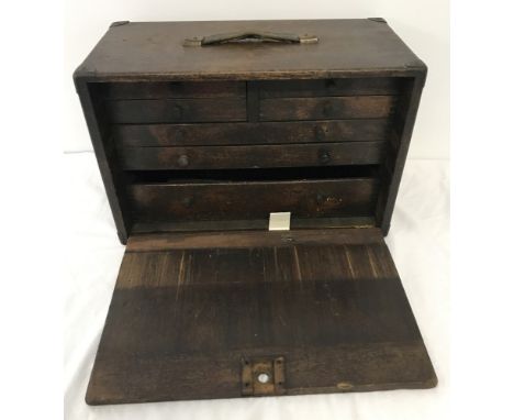 A vintage wooden engineers tool cabinet with 7 internal drawers. Containing an assortment of vintage tools to include 2 micro