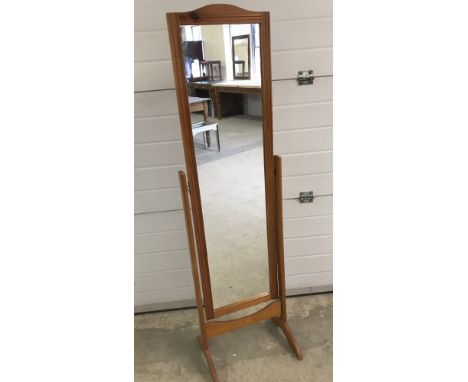 A light wood framed cheval mirror.  Approx. 150cm tall including stand.