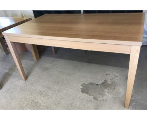 A modern light oak effect rectangular dinning table.  Approx. 150 wide x 90 deep x 75cm tall.