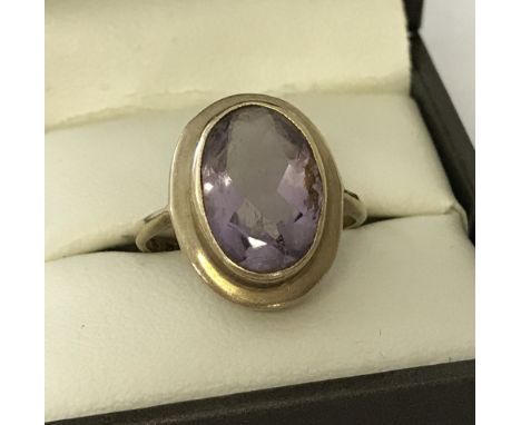 A 9ct gold bezel set  amethyst  dress ring. Approx. 3.9g. Size L