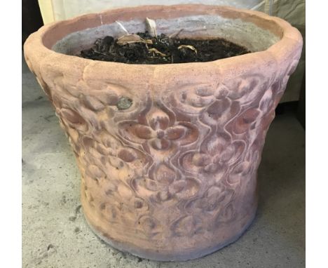 A large round terracotta garden planter with decorative sides.  Approx. 42cm diameter x 34cm tall.