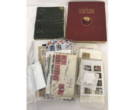 2 vintage stamp albums. Stanley Gibbons and The Strand both containing world stamps. Together with a collection of loose worl