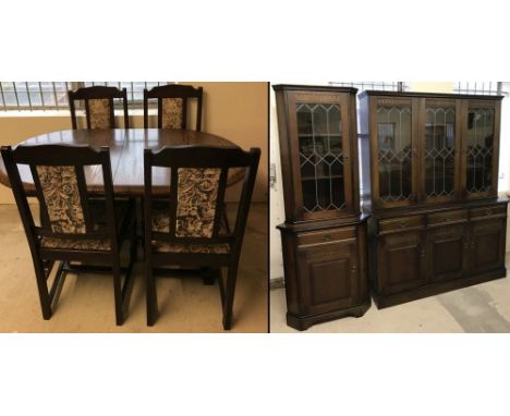 A dark oak New Plan Furniture Ltd dining room suite. Comprising; draw leaf table and 4 chairs with tapestry style upholstery,