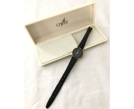 A boxed 18ct gold plated ladies watch by Christ with black face and gold tone hands. Sapphire crystal and water resistant wit