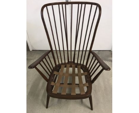 A large Ercol dark finish stick back bent frame easy chair. Without cushion. 