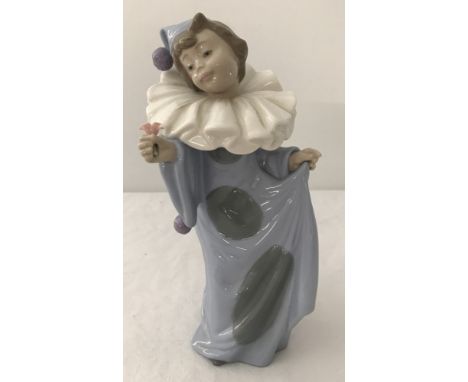 A Nao figure "Circus dreamer " blue boy clown holding a flower #1094. Unboxed Approx height 20cm.