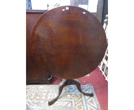 A large mahogany snap top occasional table of circular form raised on a turned pillar and tripod, 98 cm in diameter, together