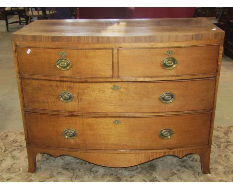 A Regency mahogany bow front caddy top bedroom chest of two short over two oak lined  long drawers with shaped apron and brac