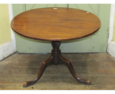 A Georgian mahogany snap top occasional table, the circular one piece top 78 cm in diameter approximately, raised on a reduce