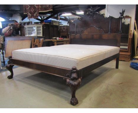 A good quality Chippendale revival mahogany double bedstead, the elaborate headboard with scrolled acanthus outline and raise