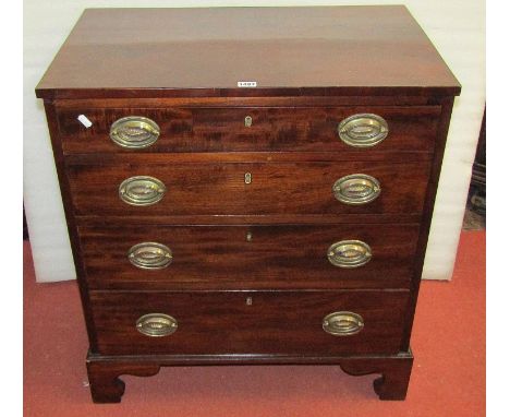 A small Georgian style mahogany chest of four long graduated drawers with oval brass plate and drop handles raised on bracket