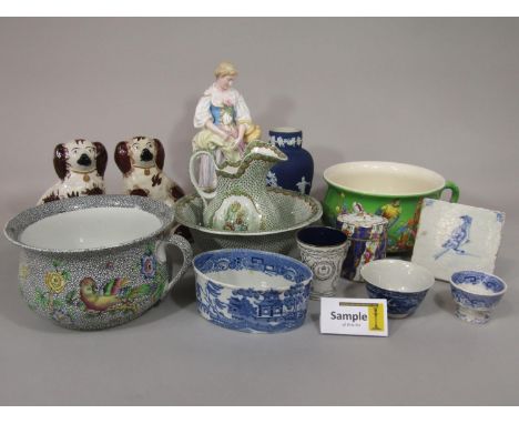 A collection of ceramics including a pair of 19th century Staffordshire spill vases with applied male and female figures, a p