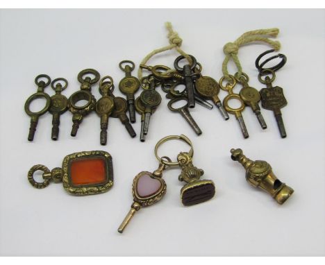 Yellow metal heart shaped watch key set with bloodstone / agate, a yellow metal intaglio cut carnelian seal depicting a runni