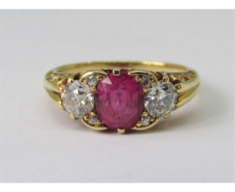 Fine 18ct pink sapphire and diamond ring, London 1994, the sapphire 7 x 5mm approx, flanked by a pair of diamonds 0.35cts eac