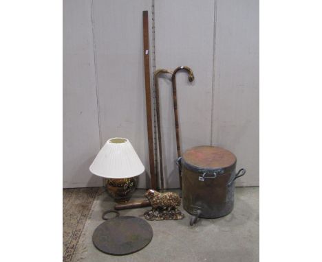 A 19th century copper two handled pan and cover of cylindrical form with brass tap, together with a pair of weathered cast ir